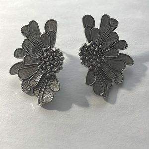 Silver toned flower petal earrings.